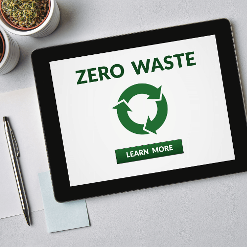 image d'une tablette ayant zero waste d'écrit à l'intérieur et avec un stylo et du papier